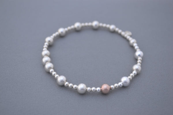 Sterling Silver small and medium bead bracelet with single Rose Gold bead detail