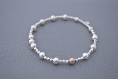 Sterling Silver small and medium bead bracelet with single Rose Gold bead detail