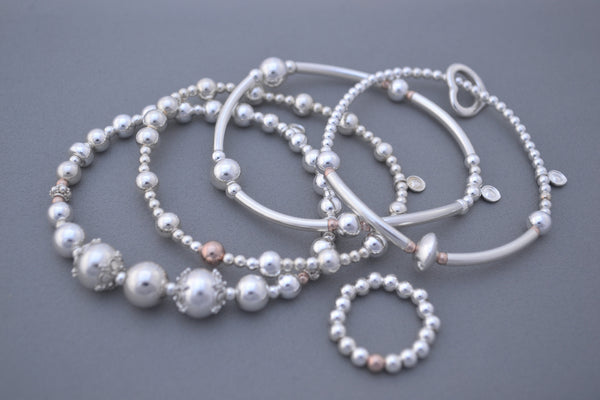 Sterling Silver small and medium bead bracelet with single Rose Gold bead detail