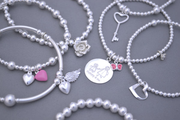 Sterling Silver noodle mixed bead bracelet with angel wing and puff heart charms