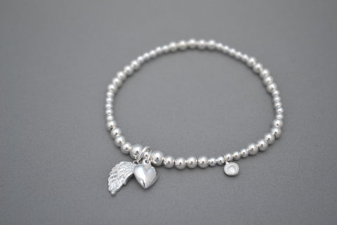 Sterling Silver mixed bead bracelet with Sterling Silver angel wing and puff heart charms.